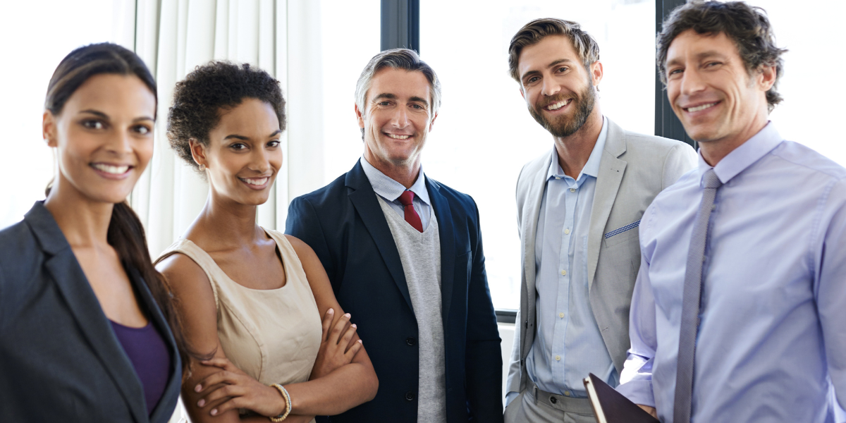 Legal team of law clerks and paralegals standing together in modern Canadian law firm office showing career opportunities in legal support roles