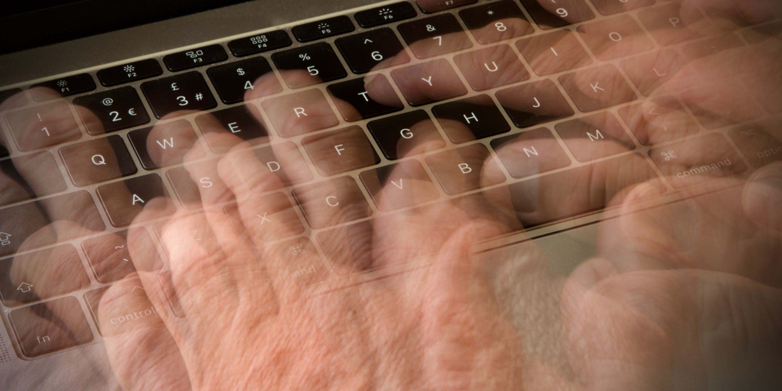 Close-up of hands typing rapidly on a keyboard, symbolizing high typing speed and efficiency.