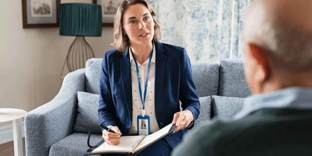 A compassionate community support worker assisting an elderly person, showcasing the rewarding opportunities in a community support services career.