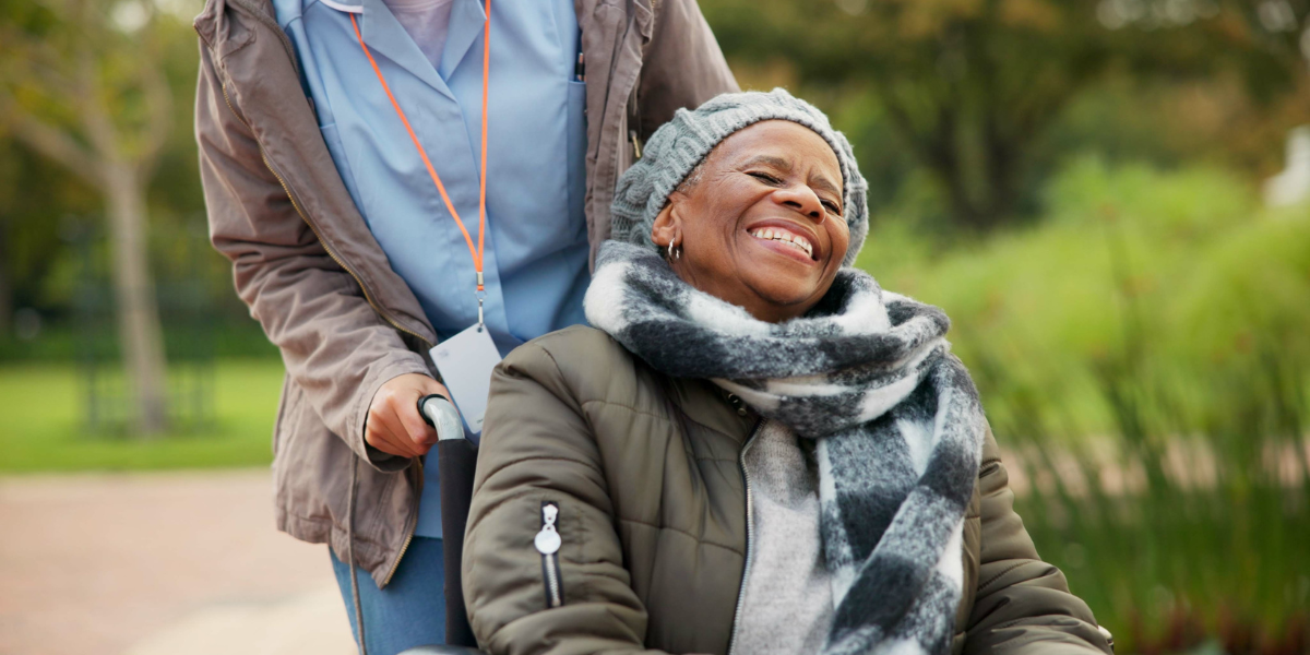 An elderly person enjoying quality time with a compassionate community support worker, illustrating the impact of a community support services career.