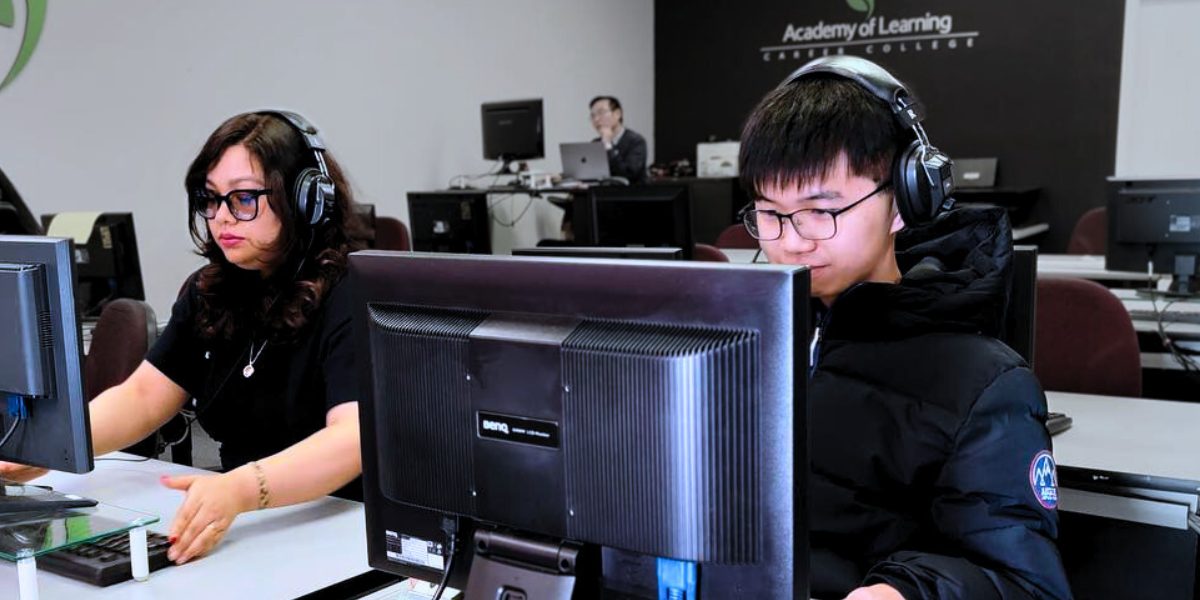 Adult students at individual computer stations, learning new skills through hands-on practice at Academy of Learning Career College—showcasing immediate application, one of the article’s featured learning techniques.