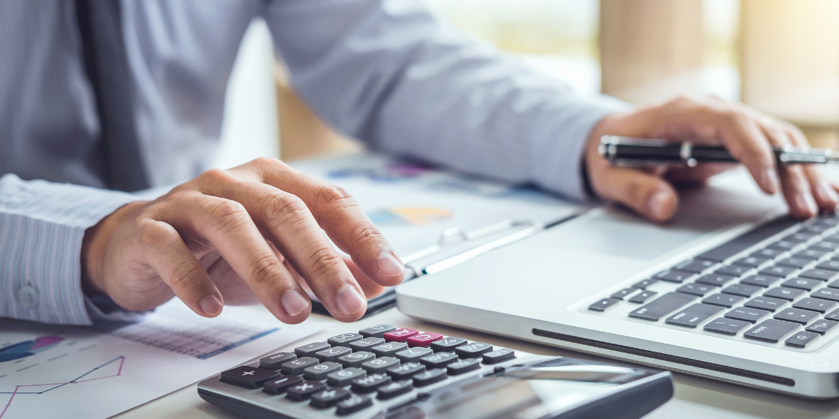 Accounting technicians reviewing financial data, charts, and reports - demonstrating the collaborative nature of accounting diploma programs and careers accessible without university education in Canada.
